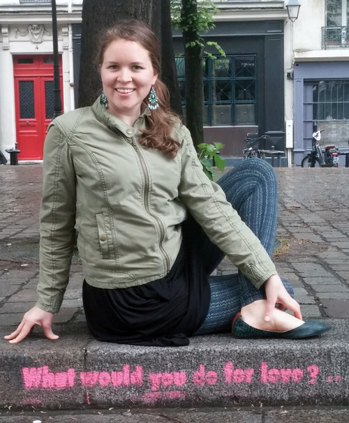 Sidewalk art with a seated twist.  " what would you do for love?" 